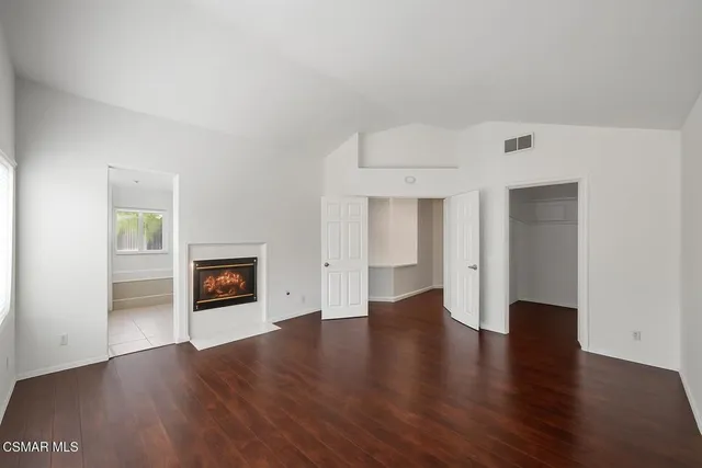 a view of empty room with a fireplace