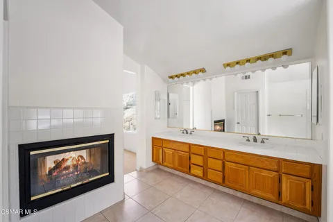 a spacious bathroom with a double vanity sink and a mirror