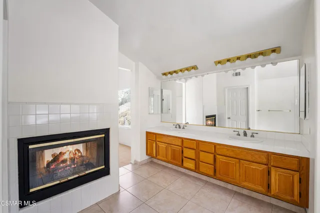 a spacious bathroom with a double vanity sink and a mirror
