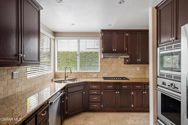 a kitchen with a sink stove and cabinets