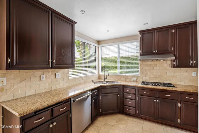 a kitchen with a sink stove and cabinets