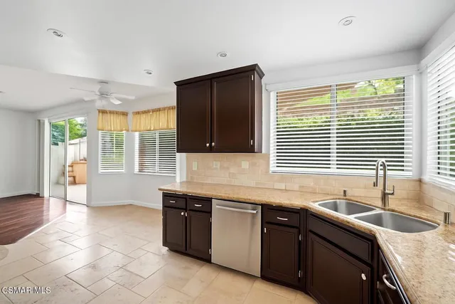 a kitchen with stainless steel appliances granite countertop a sink and a granite counter tops