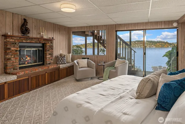 a bedroom with a large bed and a fireplace