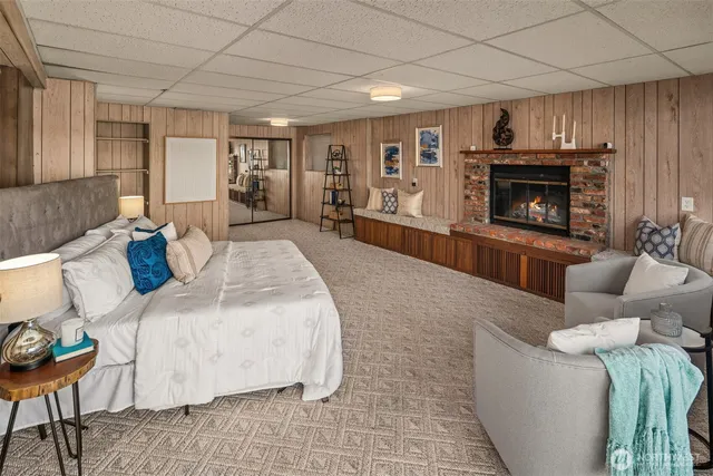 a spacious bedroom with a bed and a fireplace