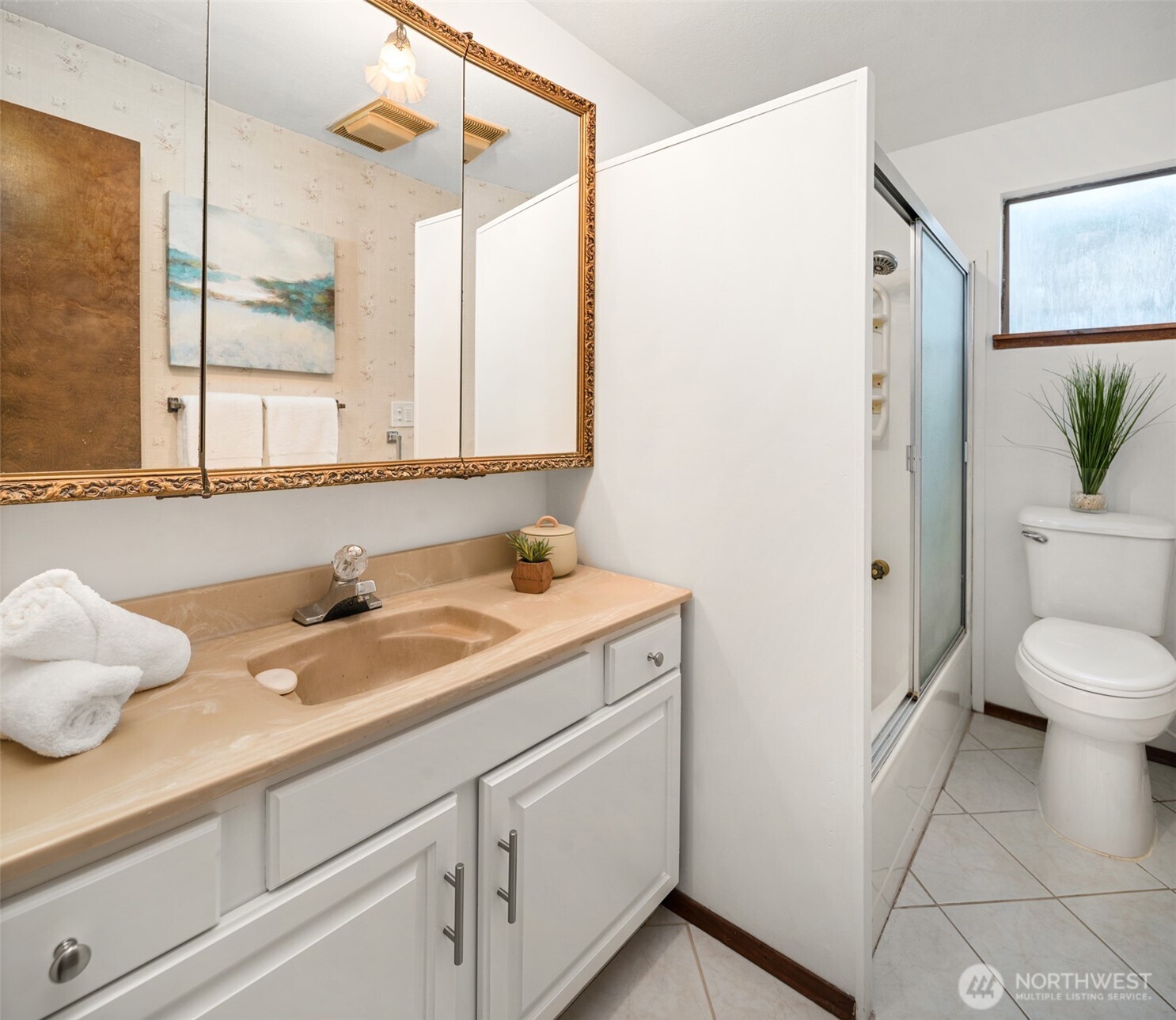 9764 Rainier Avenue South Seattle, WA 98118 - Photo 27 of 40 a bathroom with a granite countertop sink and a mirror