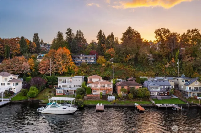 a view of house with yard and lake view