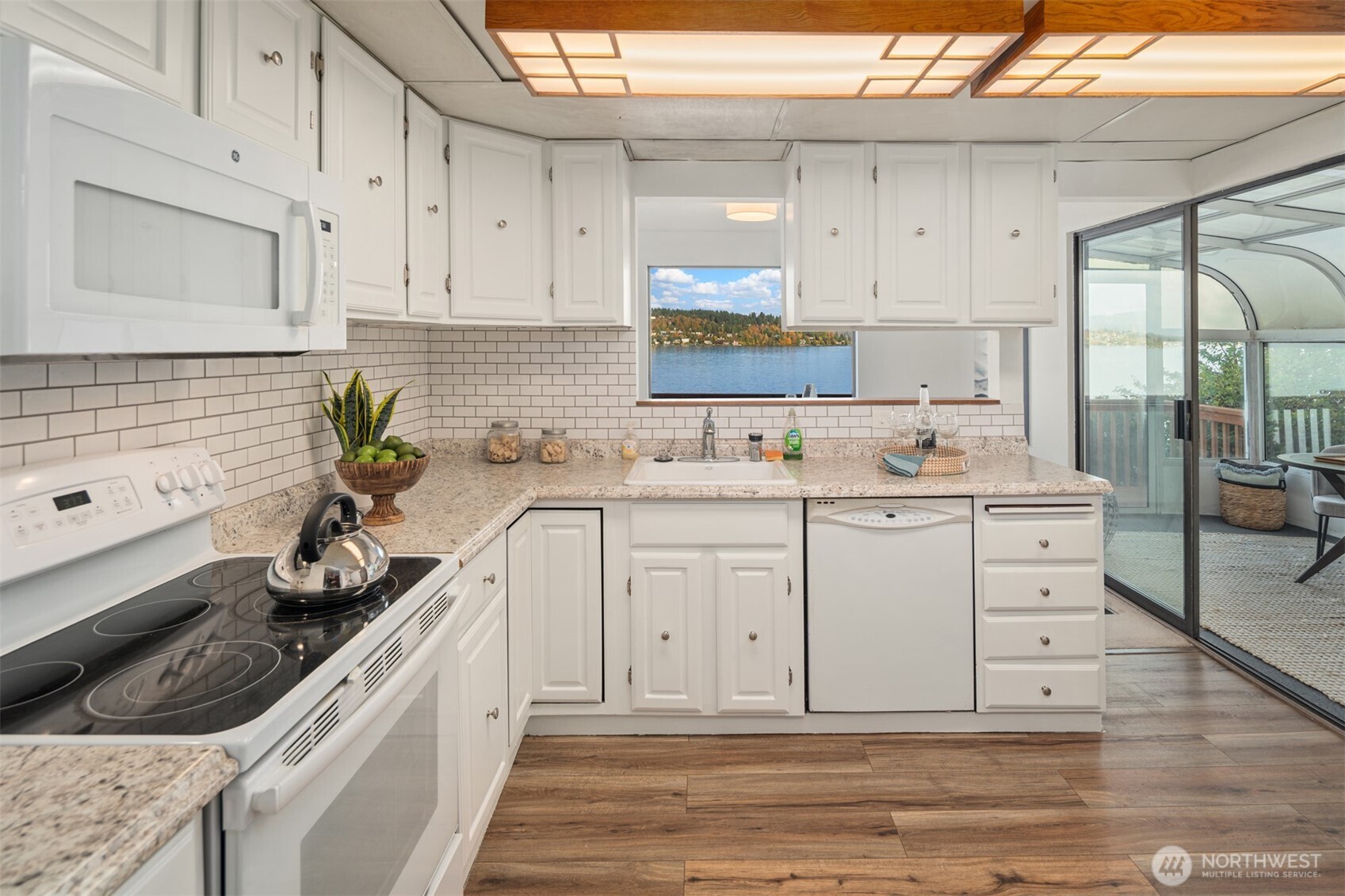 9764 Rainier Avenue South Seattle, WA 98118 - Photo 8 of 40 a kitchen with white cabinets and white appliances