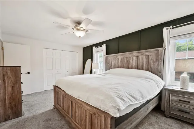 a bedroom with a large bed and a chandelier