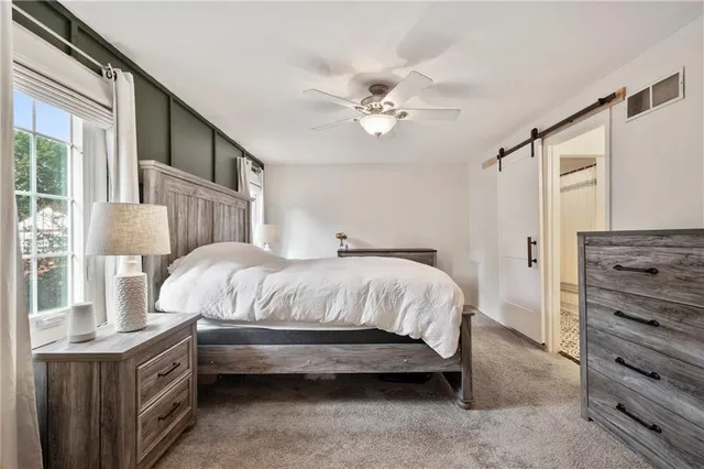 a spacious bedroom with a bed and a chandelier