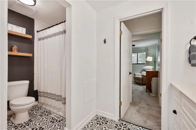 a bathroom with a toilet and a shower