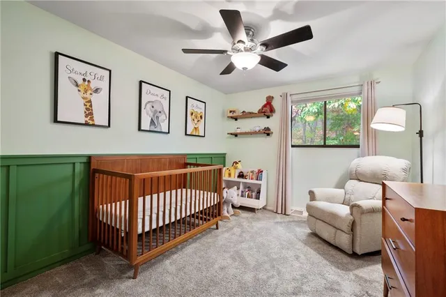 a bedroom with furniture and a large window