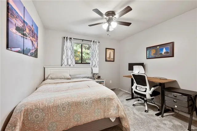 a bedroom with a bed and a desk