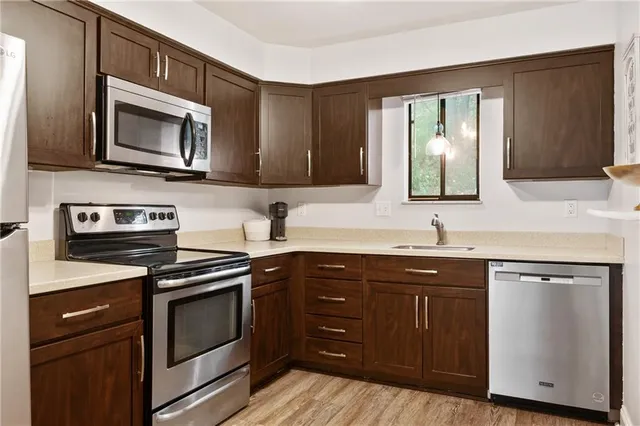 a kitchen with a sink stove and microwave