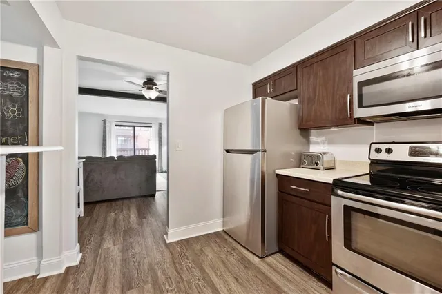 a kitchen with stainless steel appliances a refrigerator stove and sink
