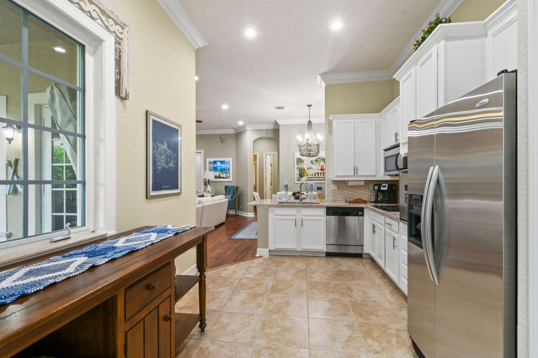 167 Arklow Avenue Jupiter, FL 33458 - Photo 14 of 60 a kitchen with refrigerator cabinets and large window
