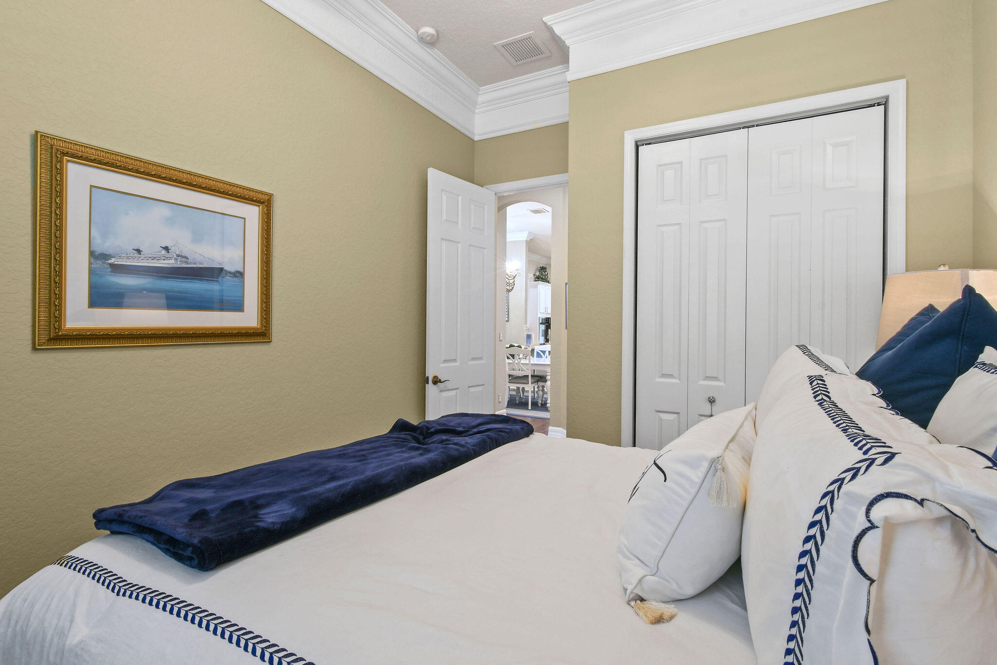 167 Arklow Avenue Jupiter, FL 33458 - Photo 31 of 60 a bedroom with a bed and a painting on the wall