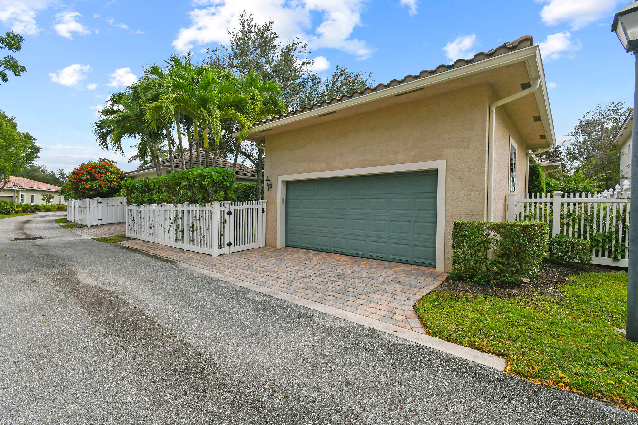 167 Arklow Avenue Jupiter, FL 33458 - Photo 49 of 60 a front view of a house with a yard and garage