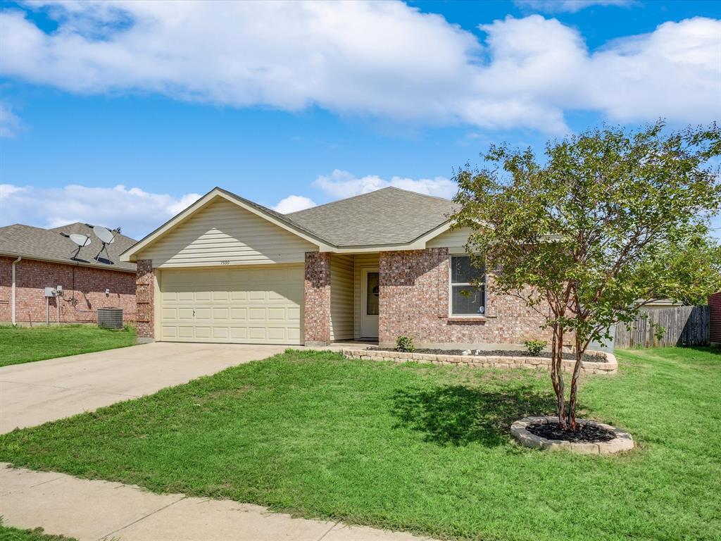1500 1st Street Sanger, TX 76266 - Photo 1 of 1 a front view of a house with a yard and garage