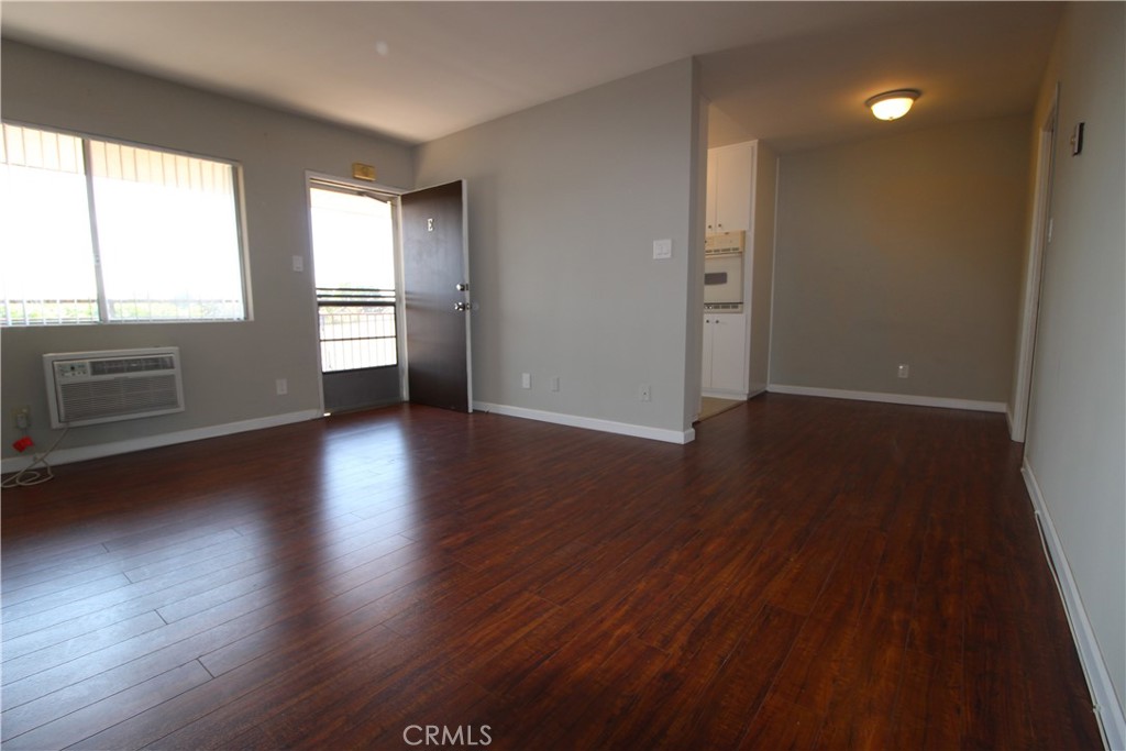 5853 Greenleaf Avenue, Unit E Whittier, CA 90601 - Photo 2 of 10 an empty room with wooden floor and windows