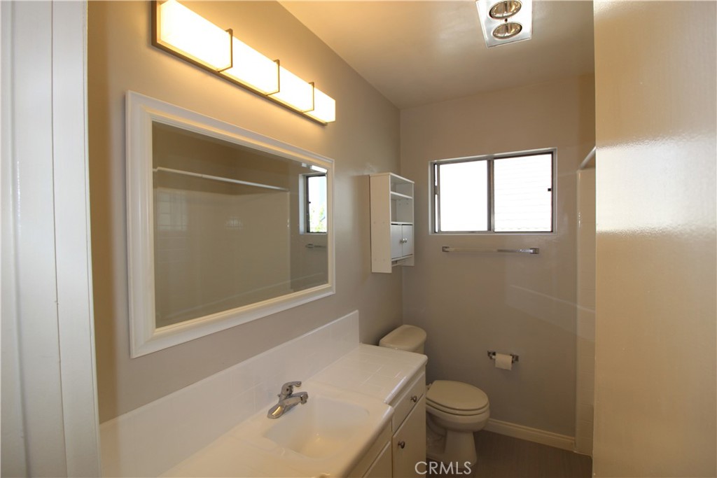 5853 Greenleaf Avenue, Unit E Whittier, CA 90601 - Photo 7 of 10 a bathroom with a sink a toilet and shower