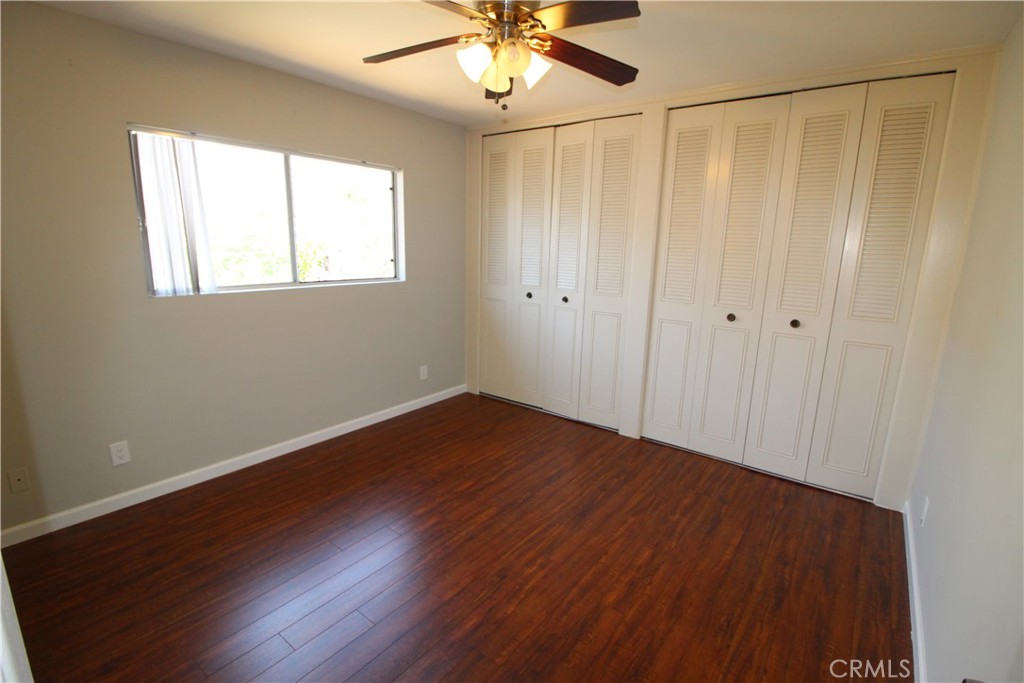 5853 Greenleaf Avenue, Unit E Whittier, CA 90601 - Photo 9 of 10 a view of an empty room with wooden floor and a window