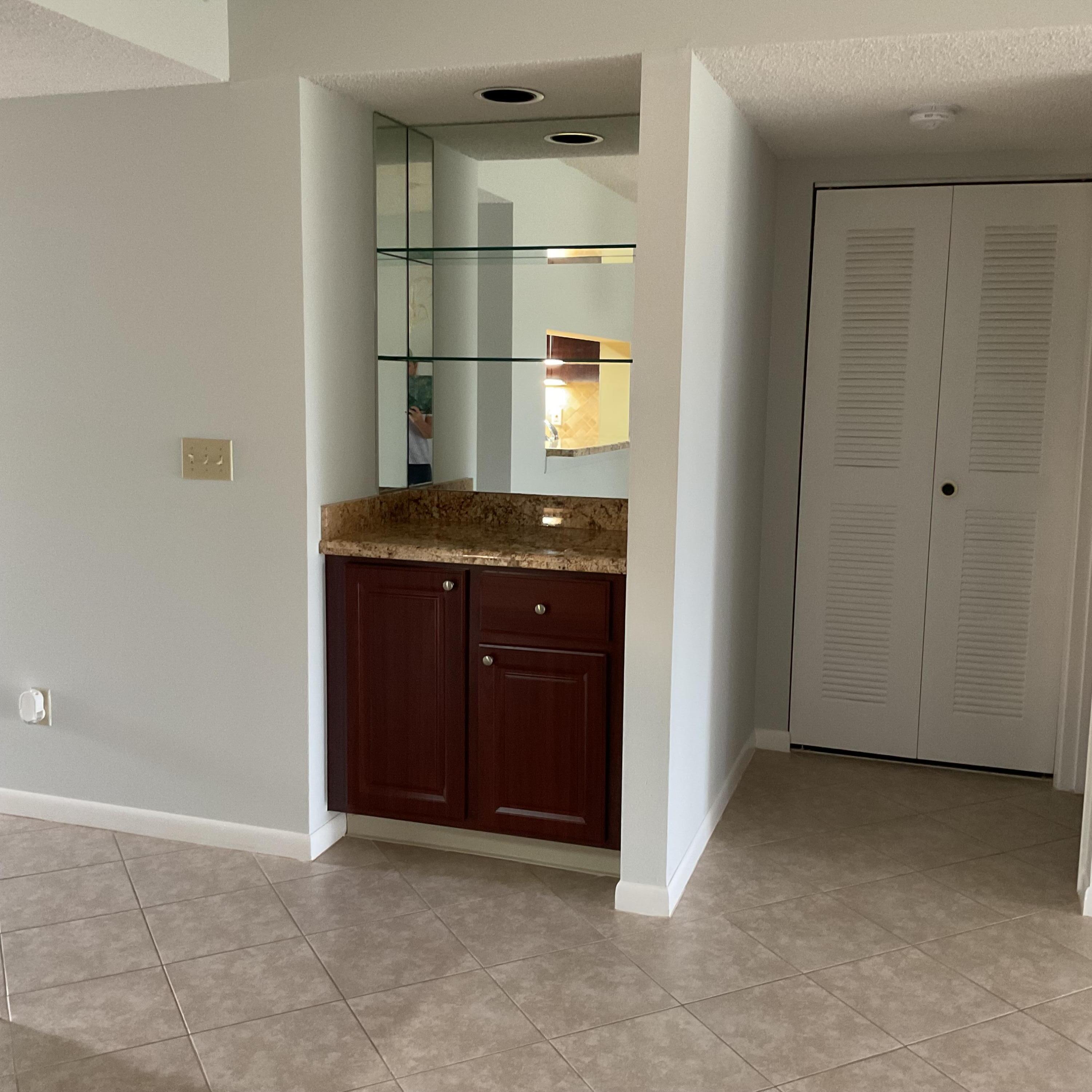 1501 Pinecrest Circle, Unit E Jupiter, FL 33458 - Photo 13 of 25 Bar and Washer & Dryer closet