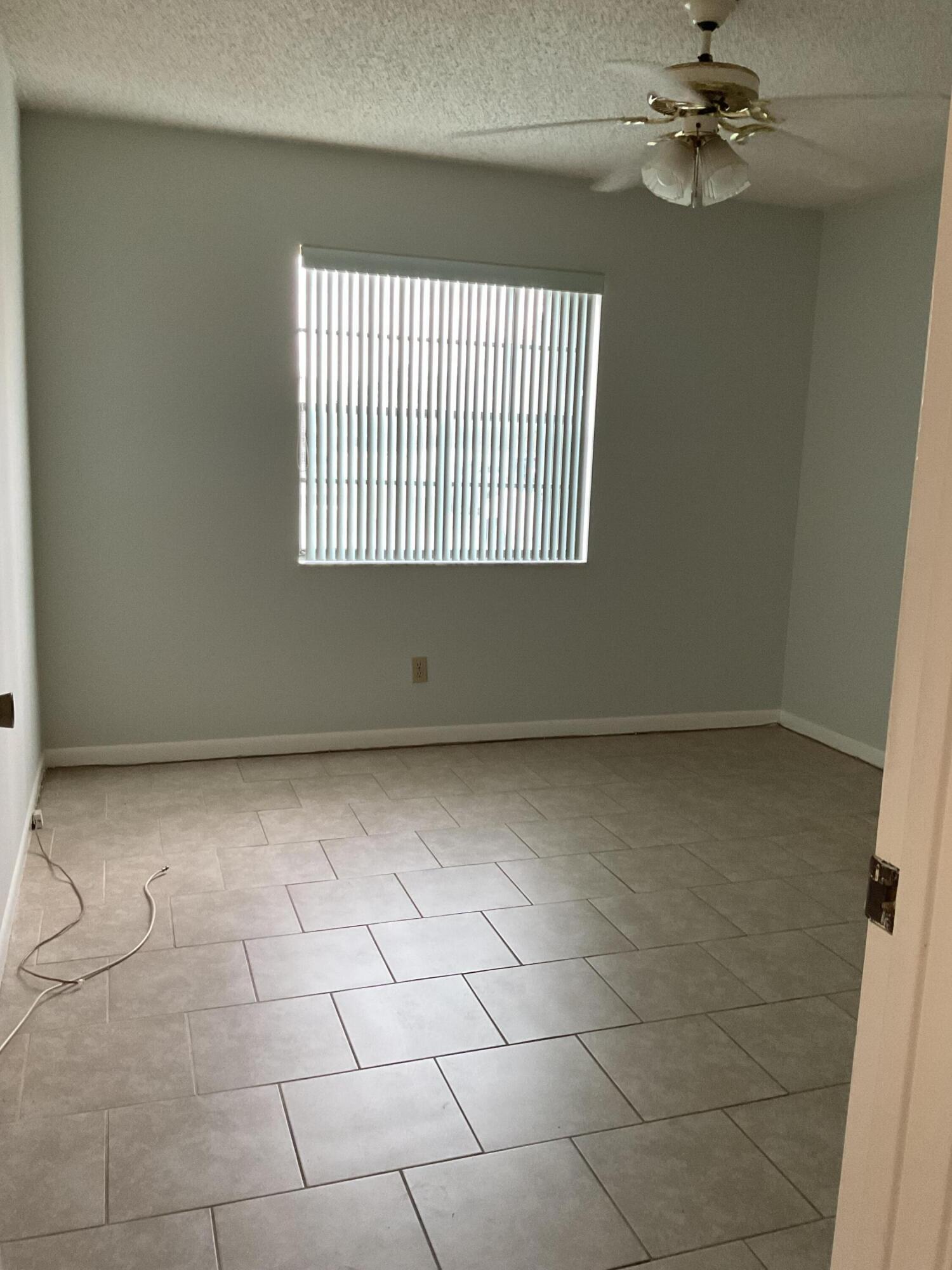 1501 Pinecrest Circle, Unit E Jupiter, FL 33458 - Photo 16 of 25 Vacant 2nd Bedroom with walk in closet