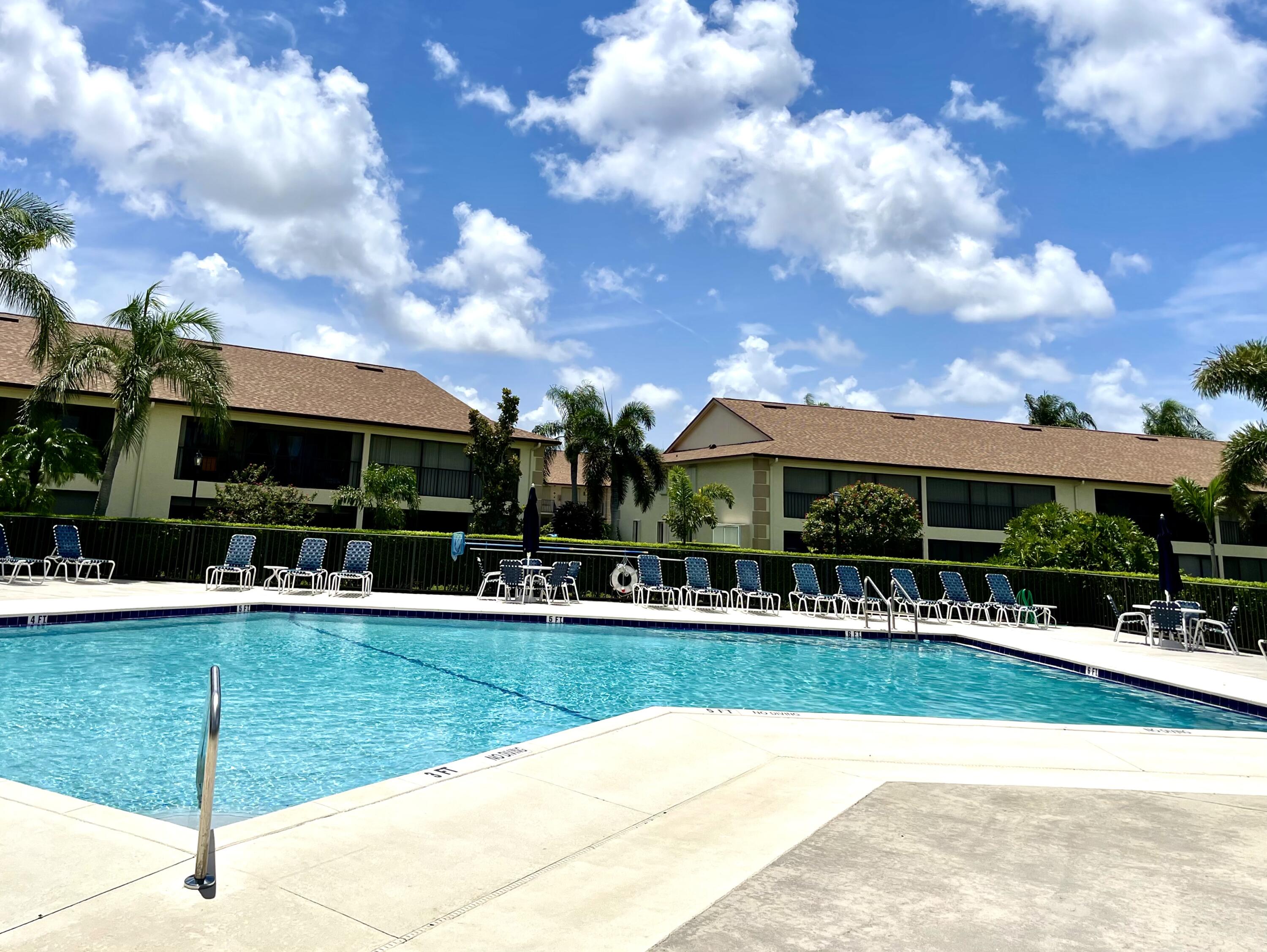 1501 Pinecrest Circle, Unit E Jupiter, FL 33458 - Photo 21 of 25 Community pool and clubhouse