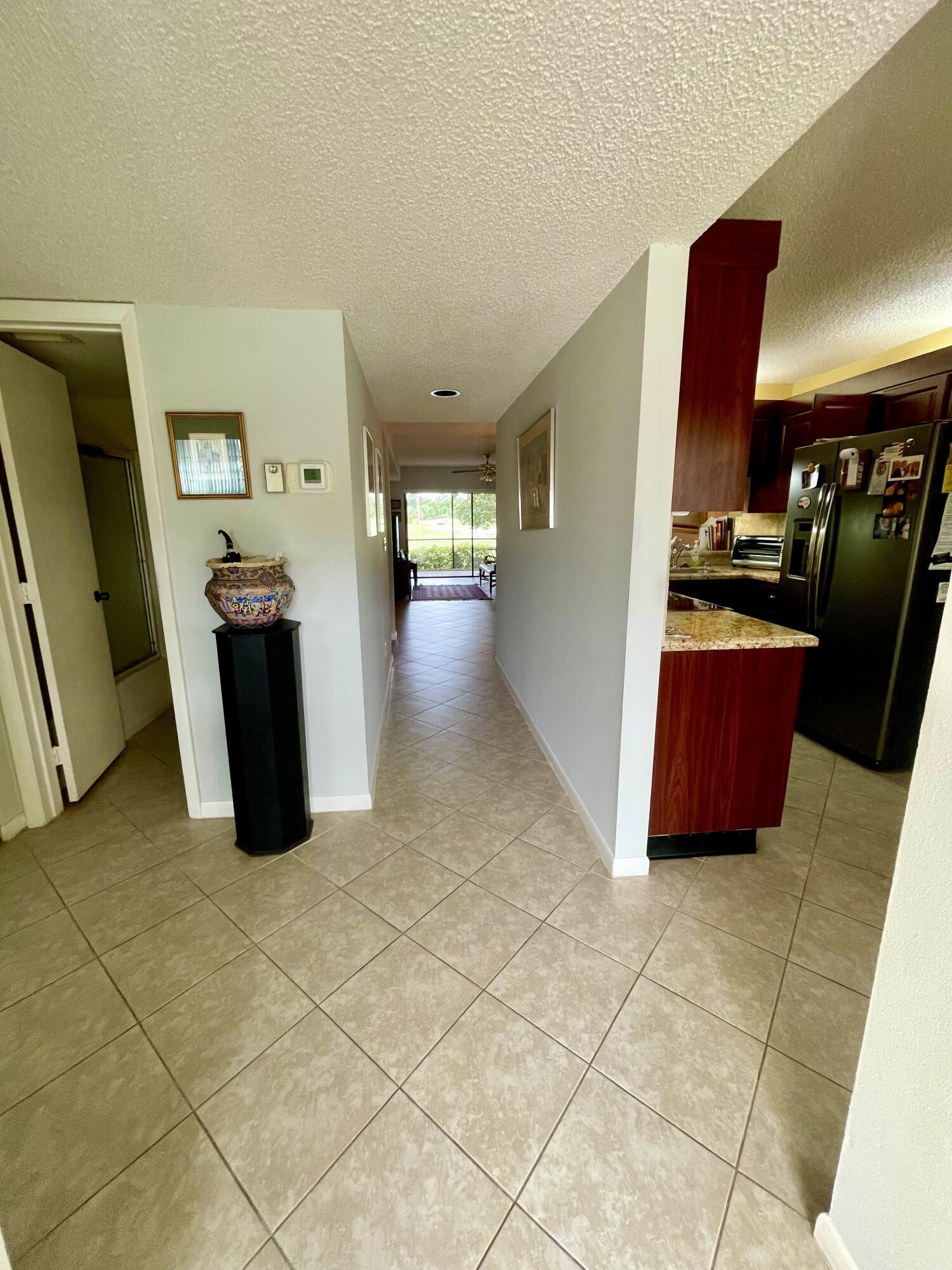 1501 Pinecrest Circle, Unit E Jupiter, FL 33458 - Photo 6 of 25 Neutral tile floors throughout