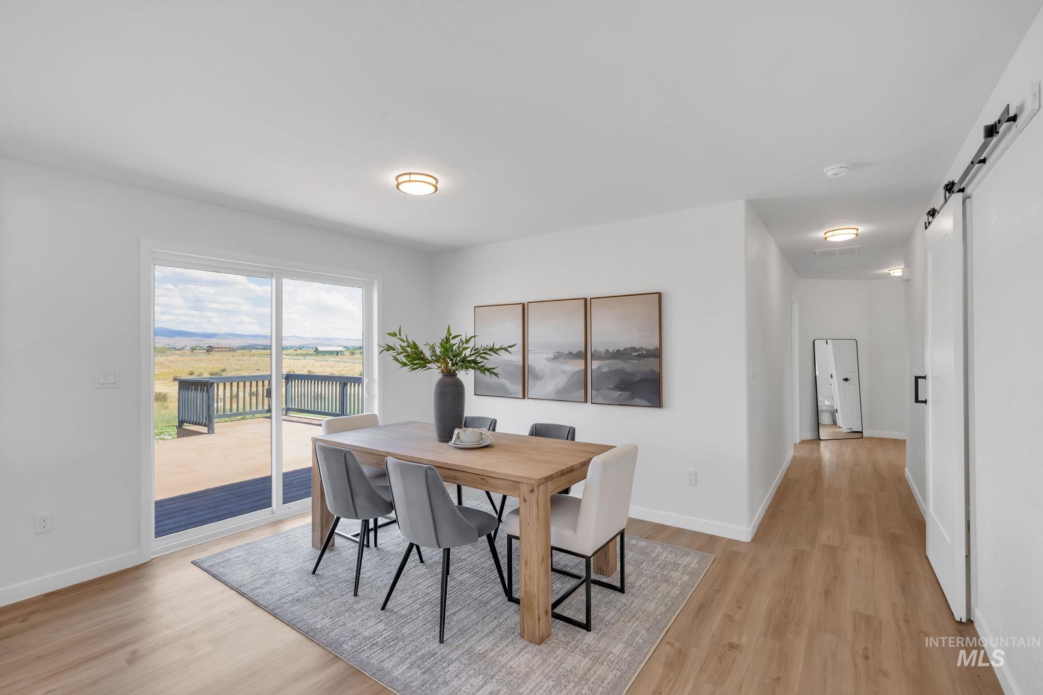 1070 West Indian Valley Road Indian Valley, ID 83632 - Photo 16 of 50 Dining area with a barn door and light wood finished floors
