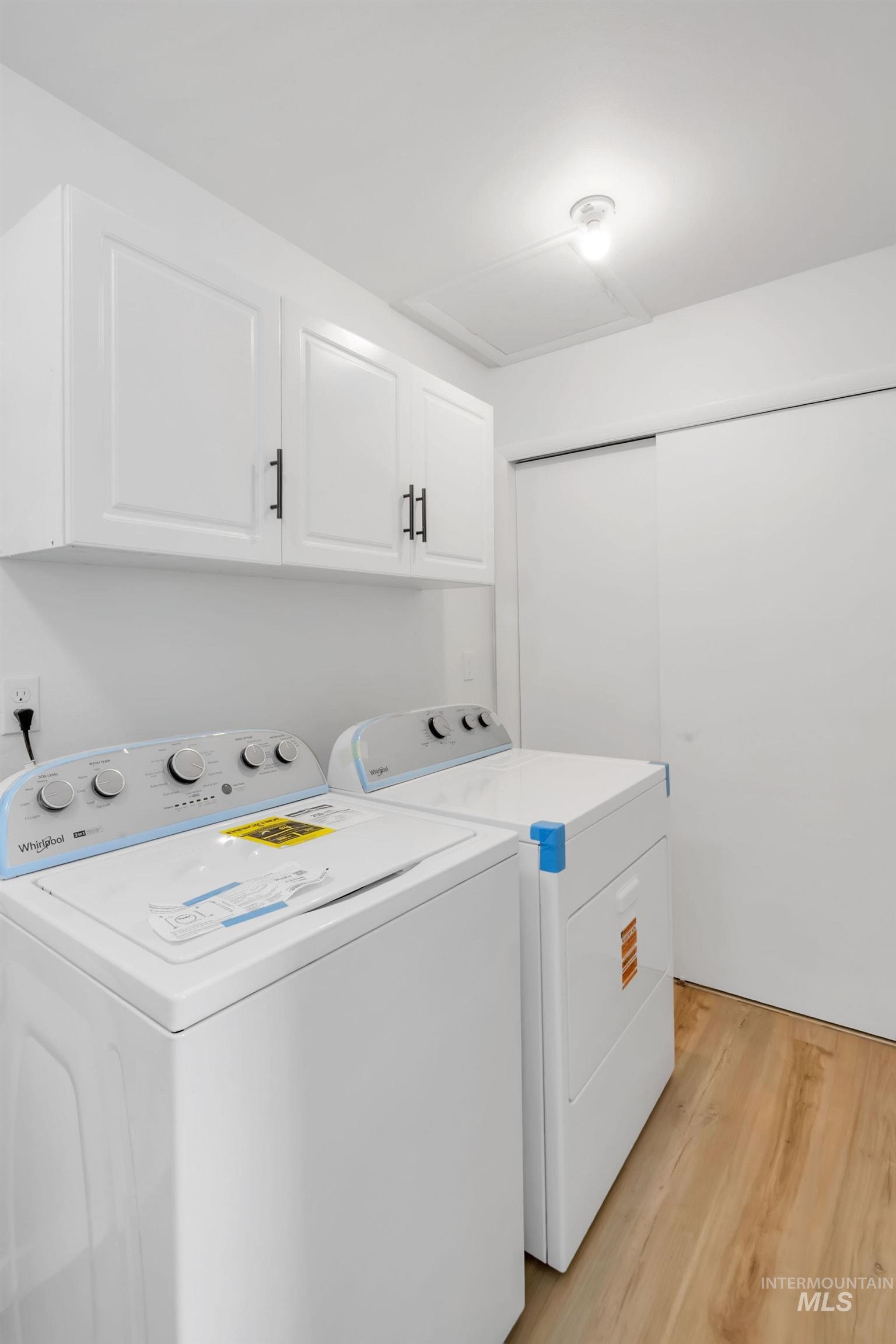 1070 West Indian Valley Road Indian Valley, ID 83632 - Photo 21 of 50 Washroom with cabinet space, washing machine and dryer, and light wood finished floors