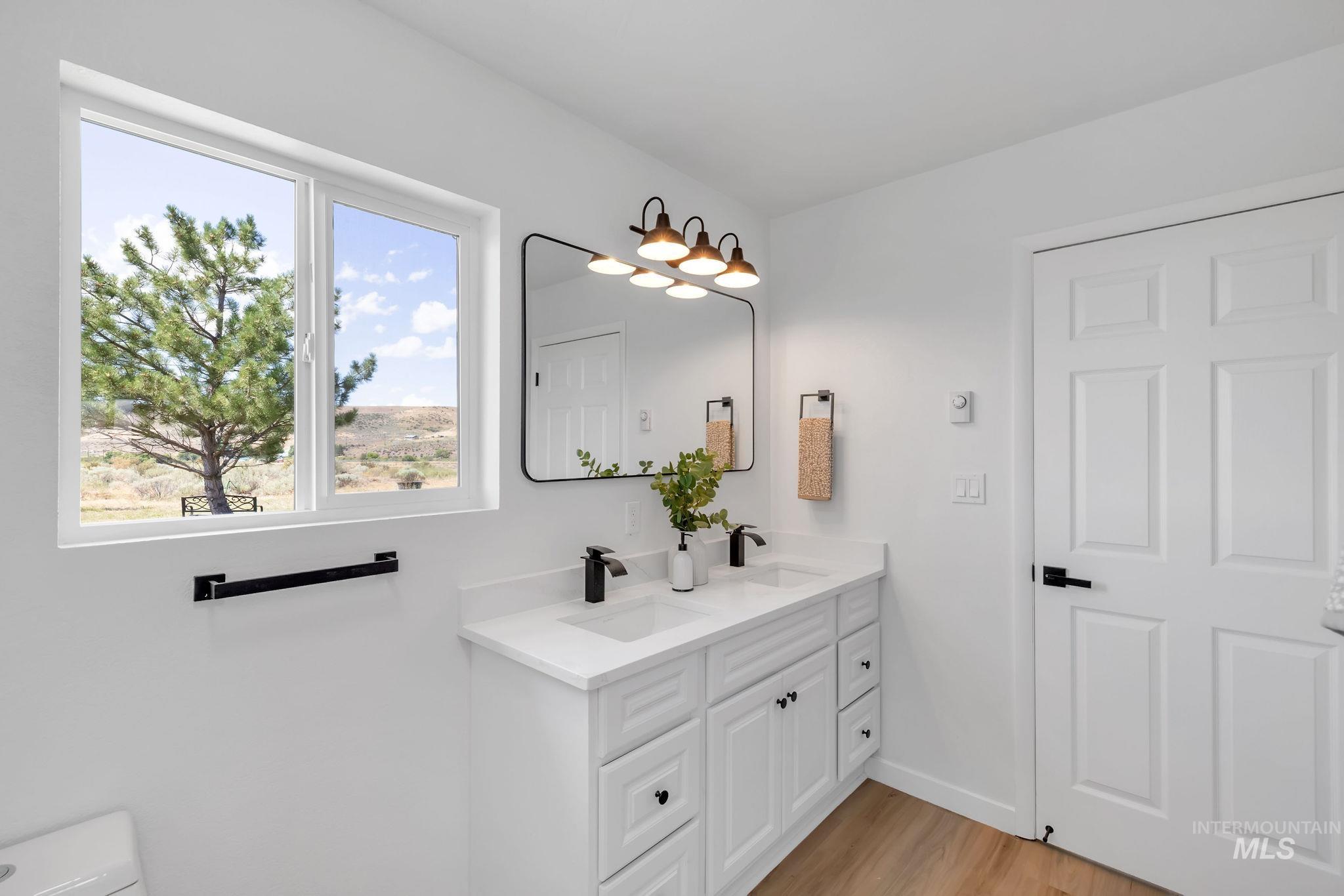 1070 West Indian Valley Road Indian Valley, ID 83632 - Photo 32 of 50 Bathroom with double vanity and wood finished floors