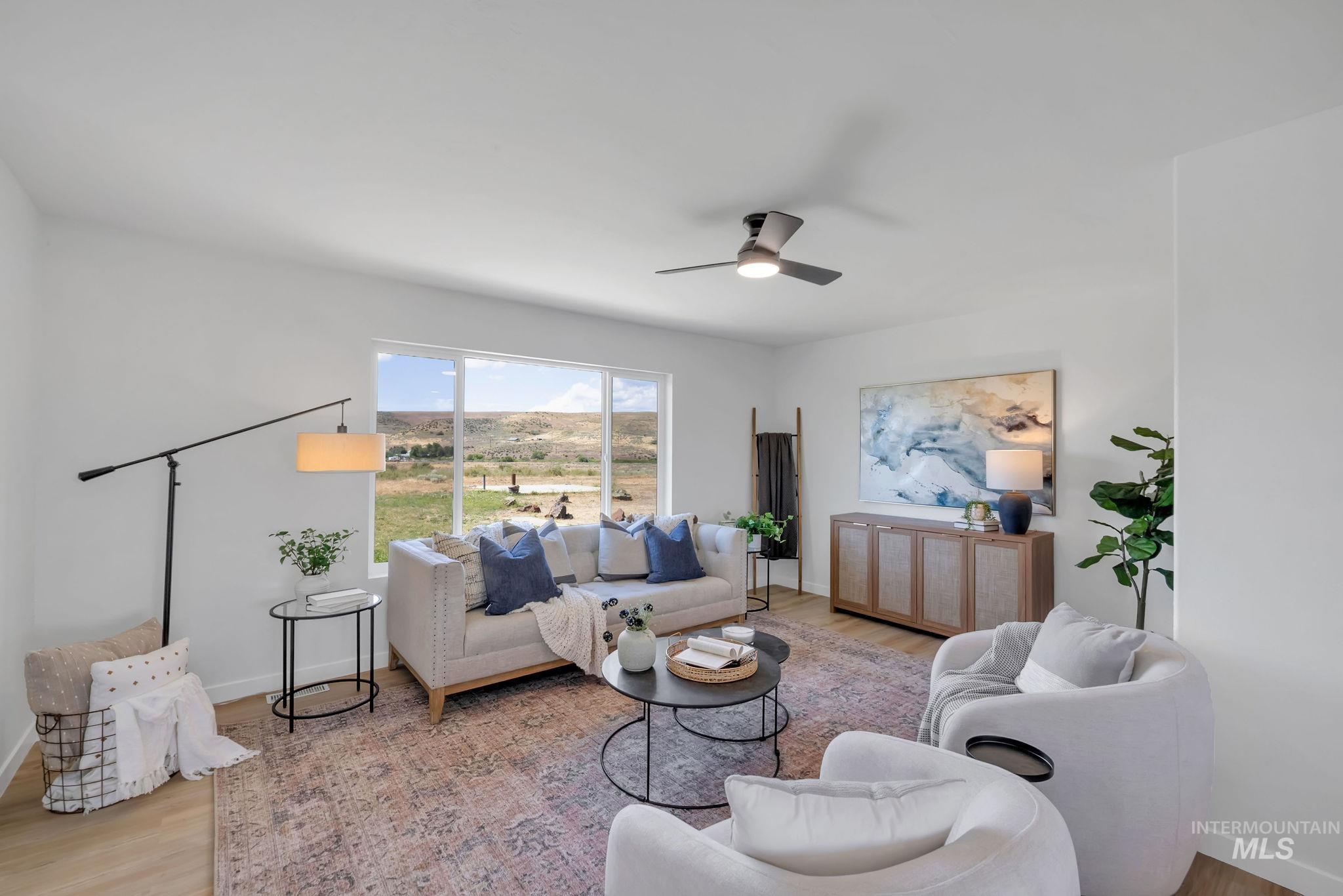 1070 West Indian Valley Road Indian Valley, ID 83632 - Photo 7 of 50 Living room with wood finished floors and a ceiling fan