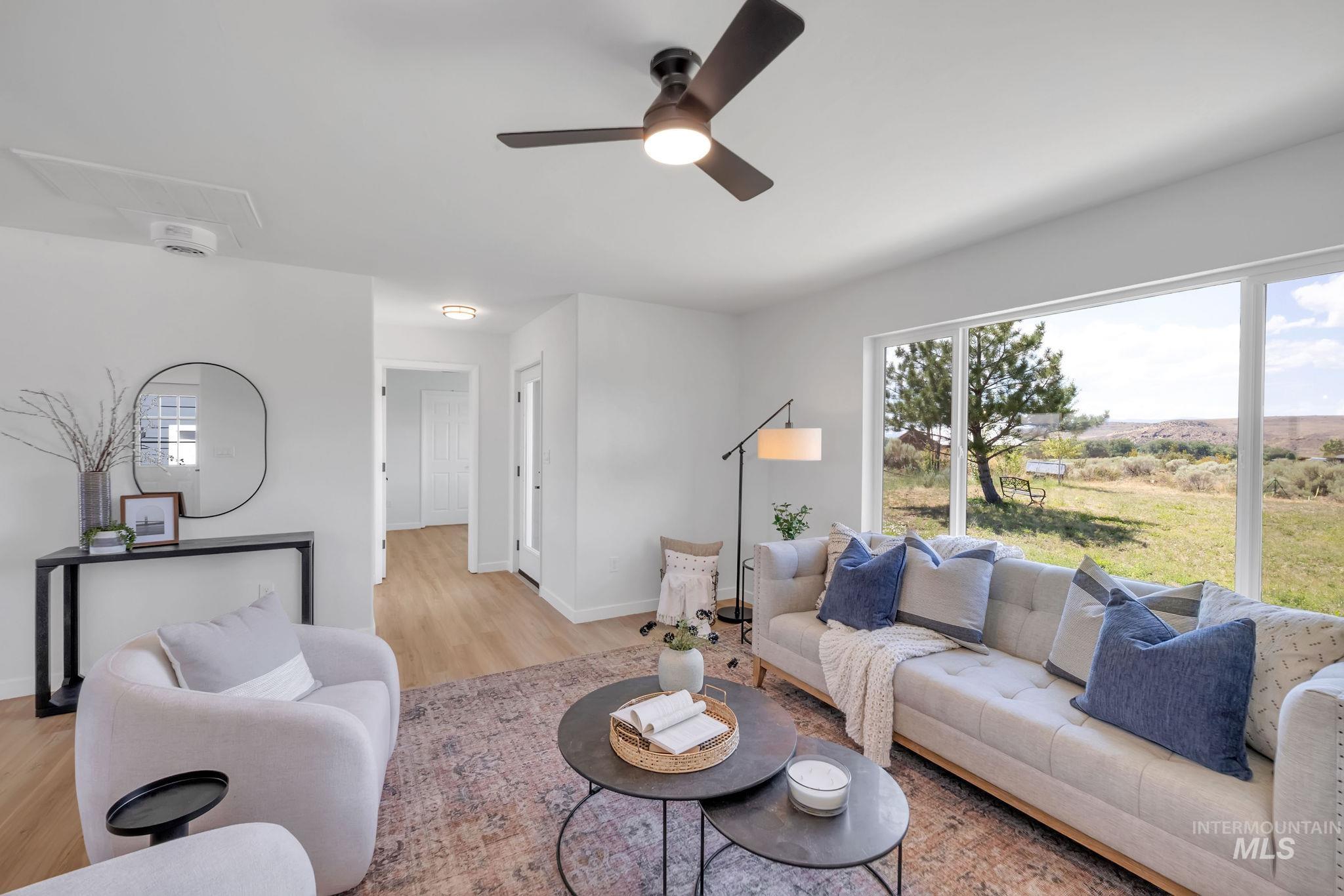 1070 West Indian Valley Road Indian Valley, ID 83632 - Photo 9 of 50 Living room with light wood finished floors and a ceiling fan