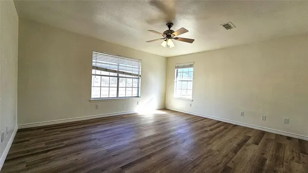 a view of a room with a wooden floor