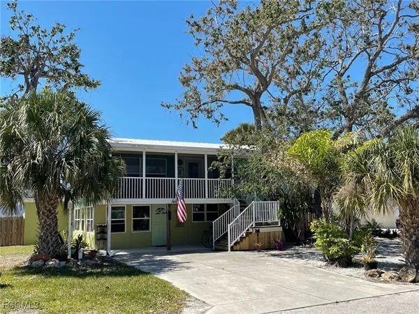 a view of a house with backyard porch and sitting area