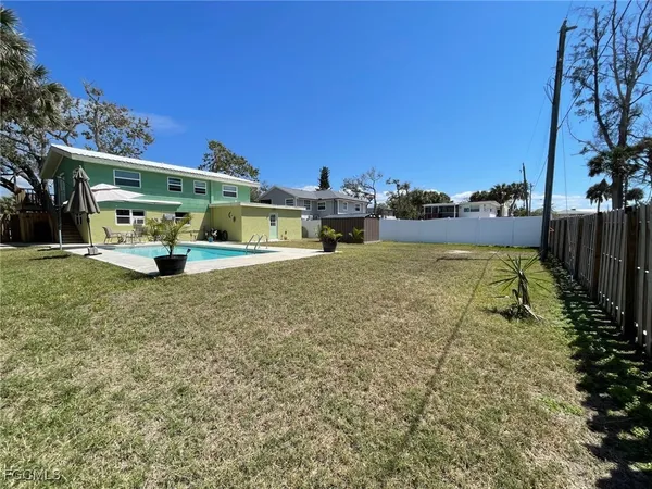a view of a swimming pool with an outdoor seating and a garden