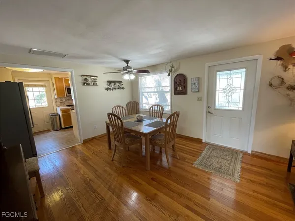 a view of a dining room with furniture and wooden floor