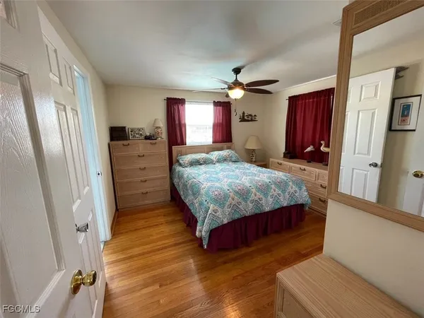 a bedroom with a bed closet and mirror