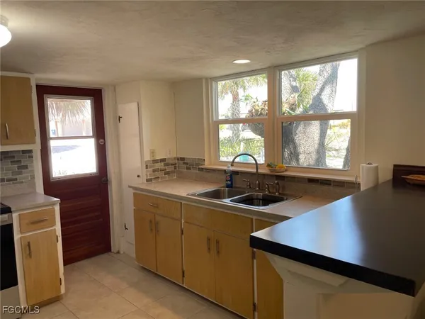 a kitchen with a sink and large window