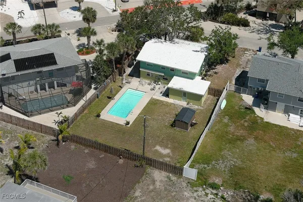 an aerial view of a house with a yard