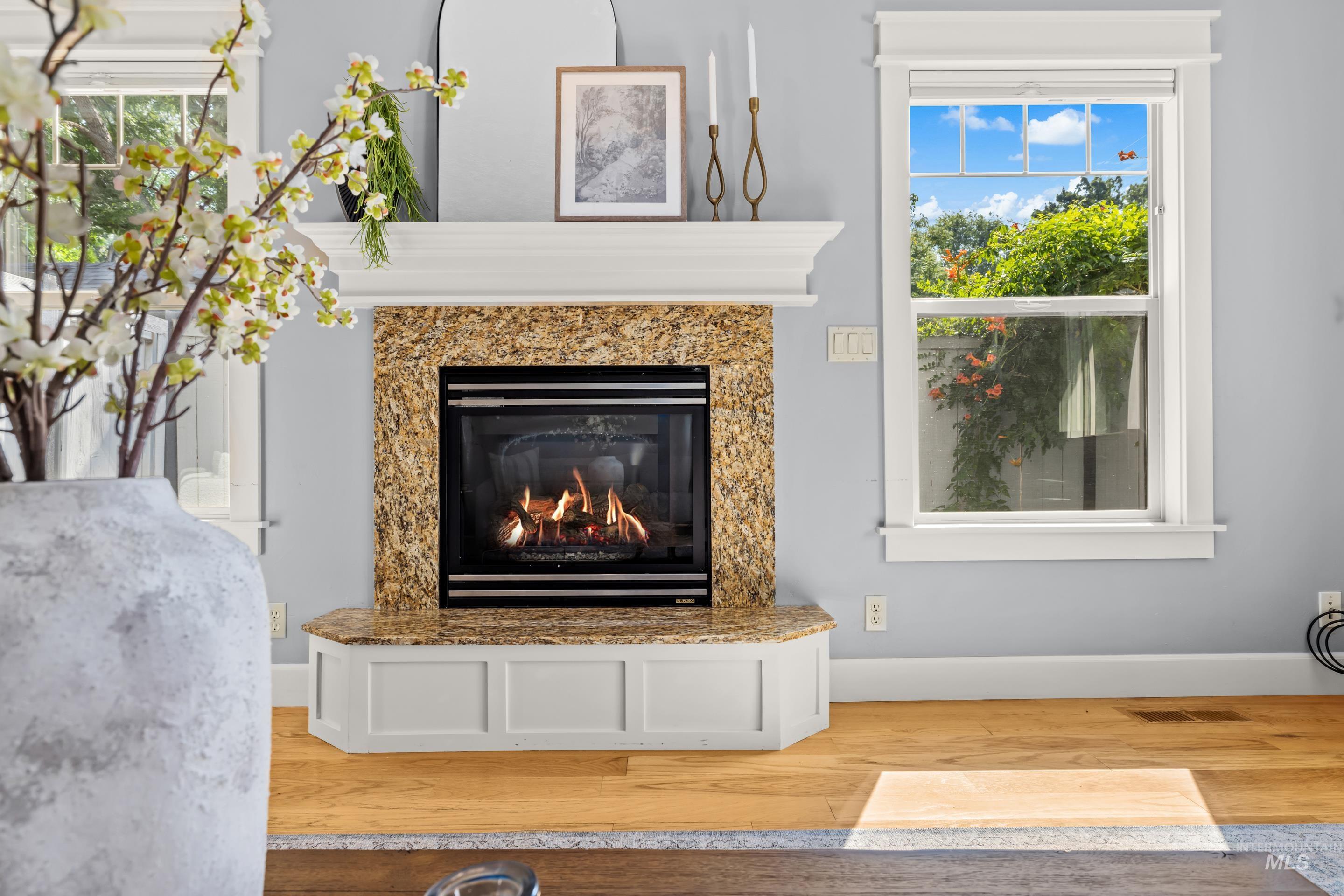 1862 West Ridenbaugh Street Boise, ID 83702 - Photo 9 of 40 Fireplace featuring a stone surround and a white mantle