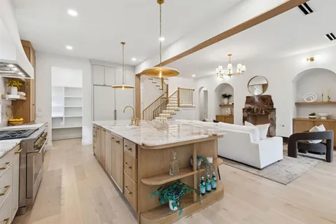 a kitchen with counter top space a sink and appliances
