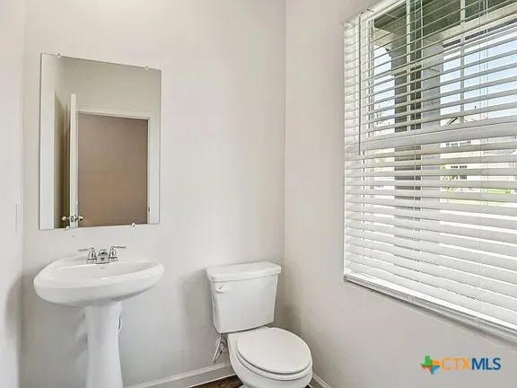 a bathroom with a sink a mirror and a toilet