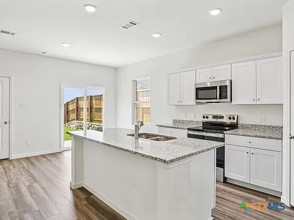 a kitchen with a sink stove and microwave