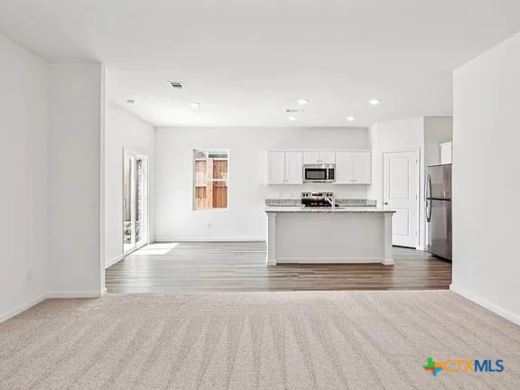 152 Mullen Taylor, TX 76574 - Photo 10 of 20 a view of kitchen with granite countertop cabinets and refrigerator