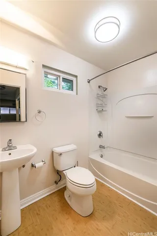 a white toilet sitting next to a bathroom sink