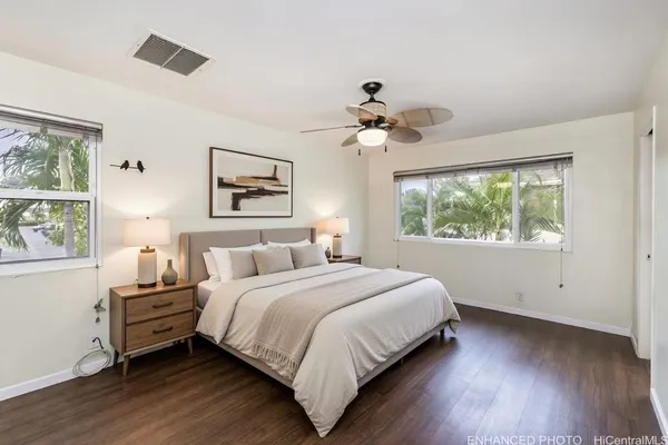 a bedroom with a large bed and a window