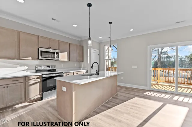 a large kitchen with stainless steel appliances granite countertop a stove a sink dishwasher a microwave oven with cabinets and wooden floor