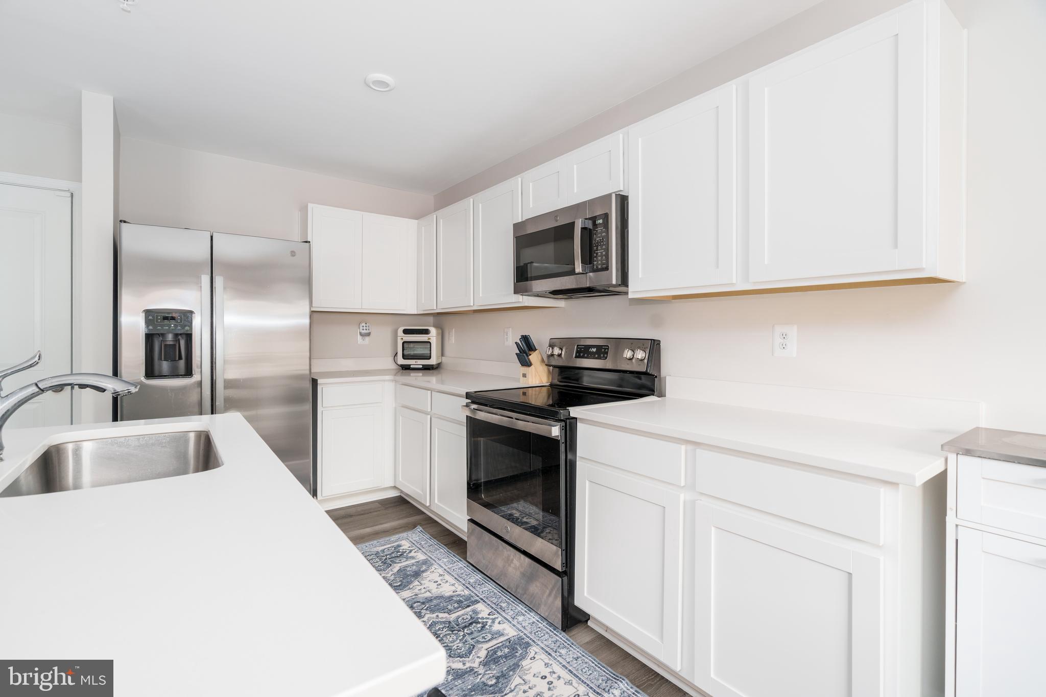 7 Olive Way Elkton, MD 21921 - Photo 5 of 21 a kitchen with granite countertop a sink a stove and refrigerator